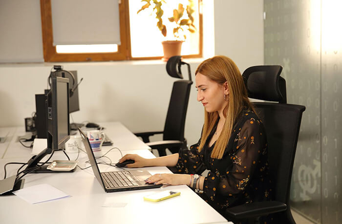 Woman sit a working on her laptop in the office