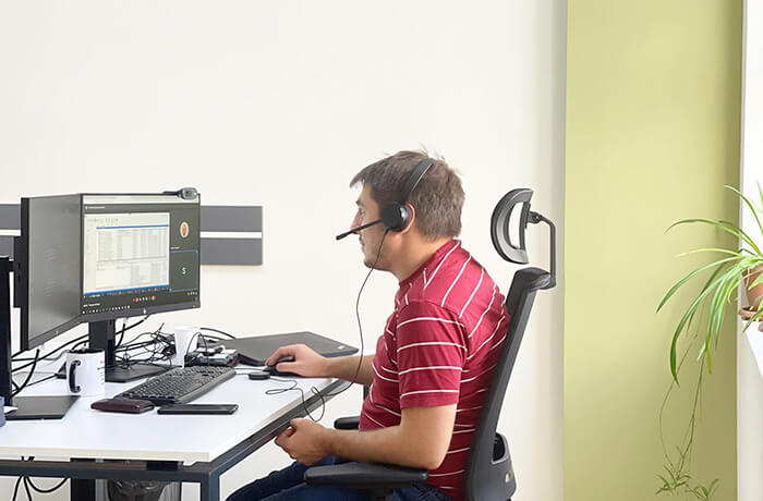 Man using a headset working on the computer
