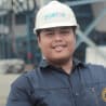 Man wearing a navy blue contractor suit and a white helmet