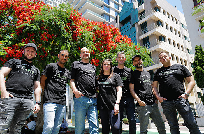 Questrade employees standing outside, with a building behind then