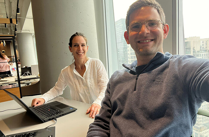Two people working with their laptops