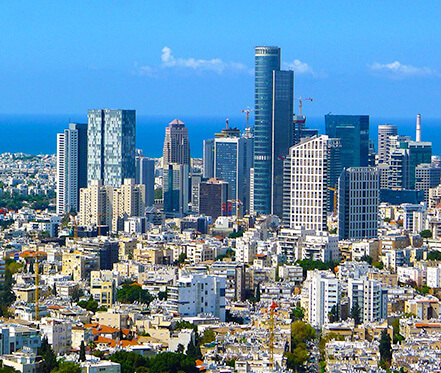 City landscape in Israel, with a blue sky and several buildings